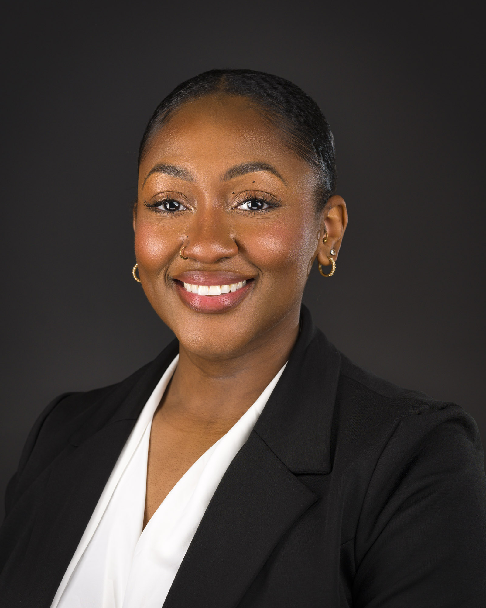 a woman in a black jacket and white shirt